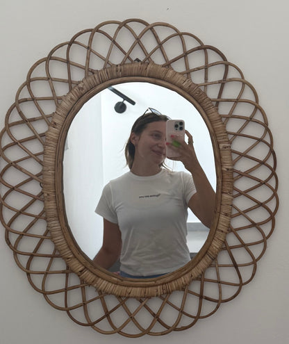 Person taking a mirror selfie with a decorative rattan-framed mirror wearing mirror moments you are enough tee