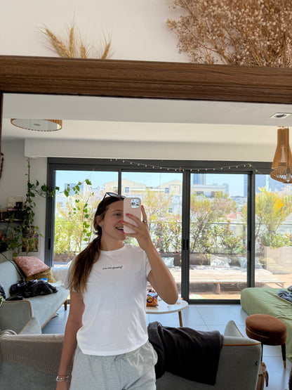 woman wearing white affirmation t-shirt you are glowing mirror selfie relaxed home outfit