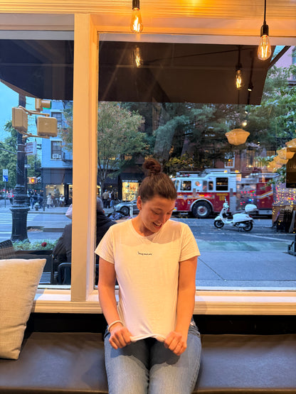 woman wearing white affirmation t-shirt you look good casual jeans cafe lifestyle