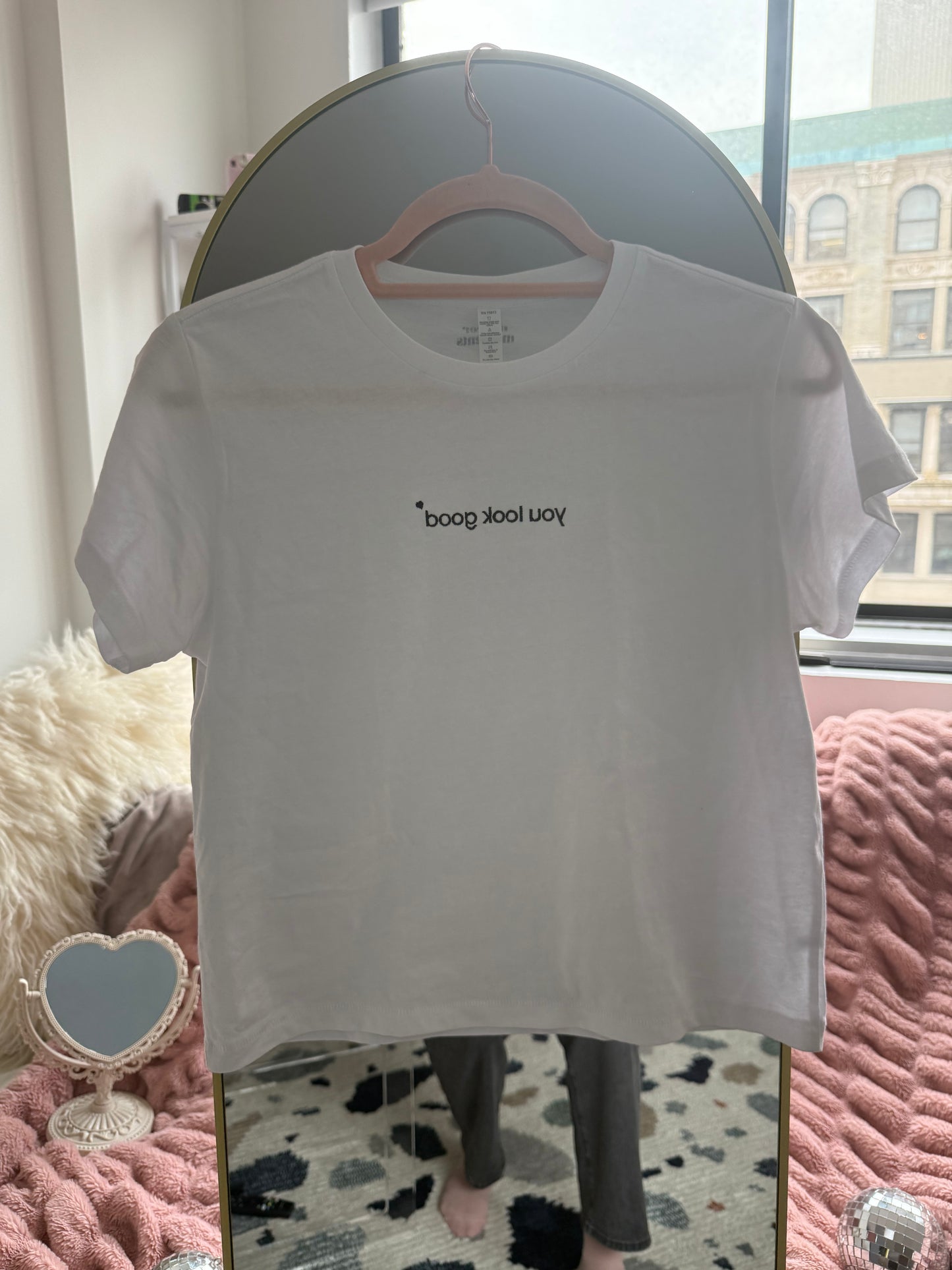 white affirmation t-shirt you look good embroidered hanging on hanger styled room aesthetic